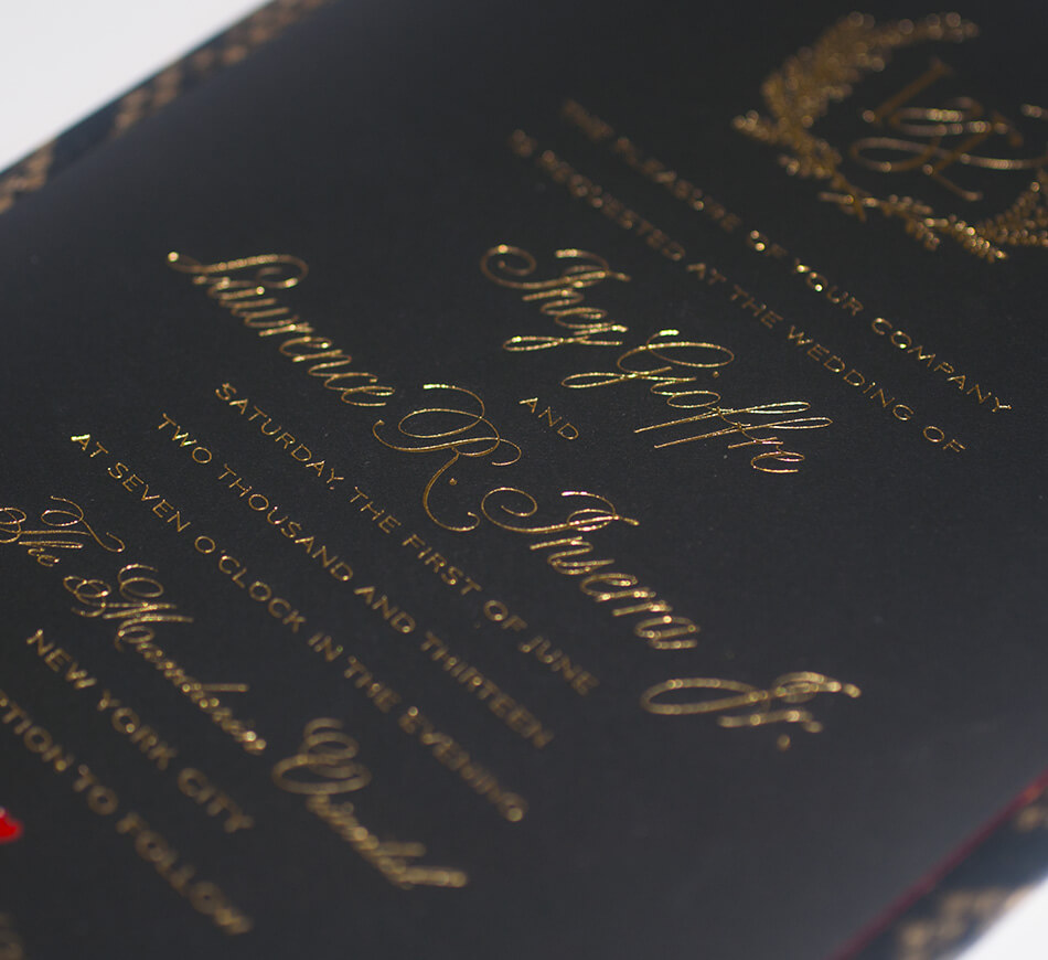 Gold lettering typography on a black invite