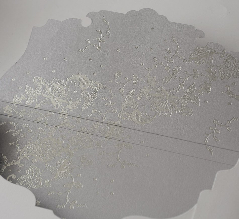 Silver foil stamped lace design on an envelope liner