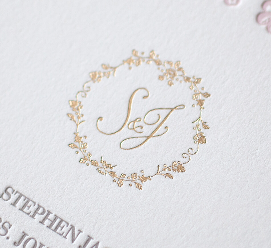Gold script monogram with a floral border