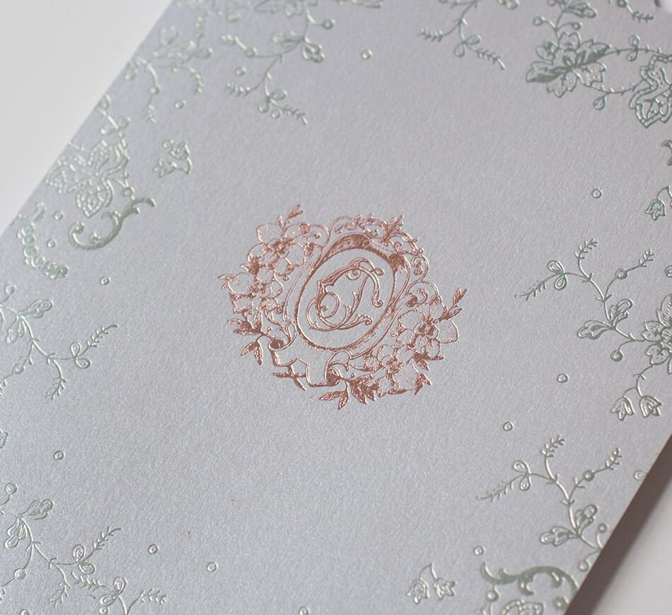 Rose gold crest and silver lace on wedding invitation