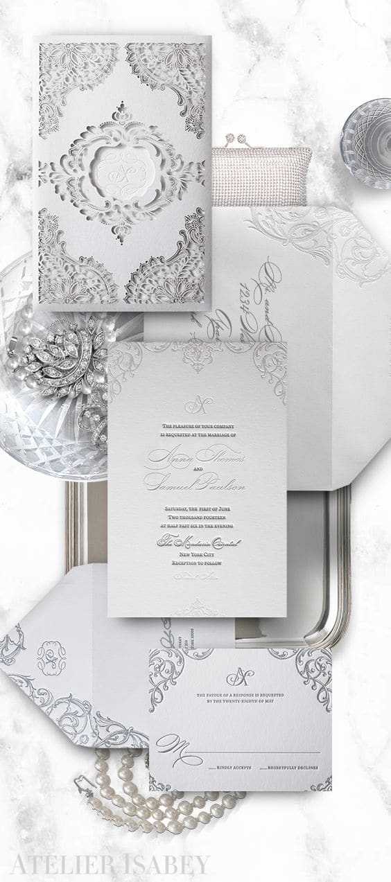 White wedding invitation with a laser cut lace sleeve | By Atelier Isabey