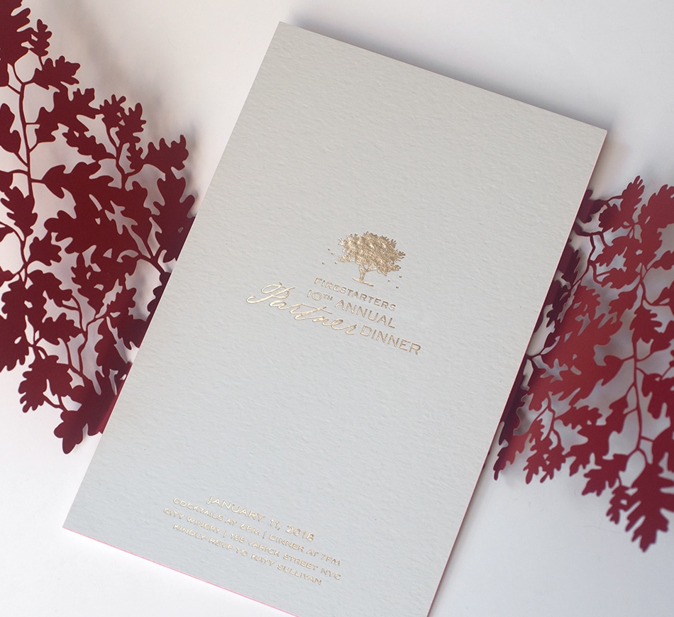 Gold foil invitation with tree and fireflies