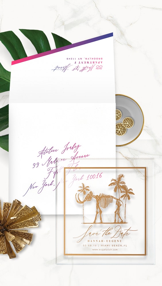 Acrylic and gold foil save the date featuring the gold mammoth installation from the Faena hotel | By Atelier Isabey