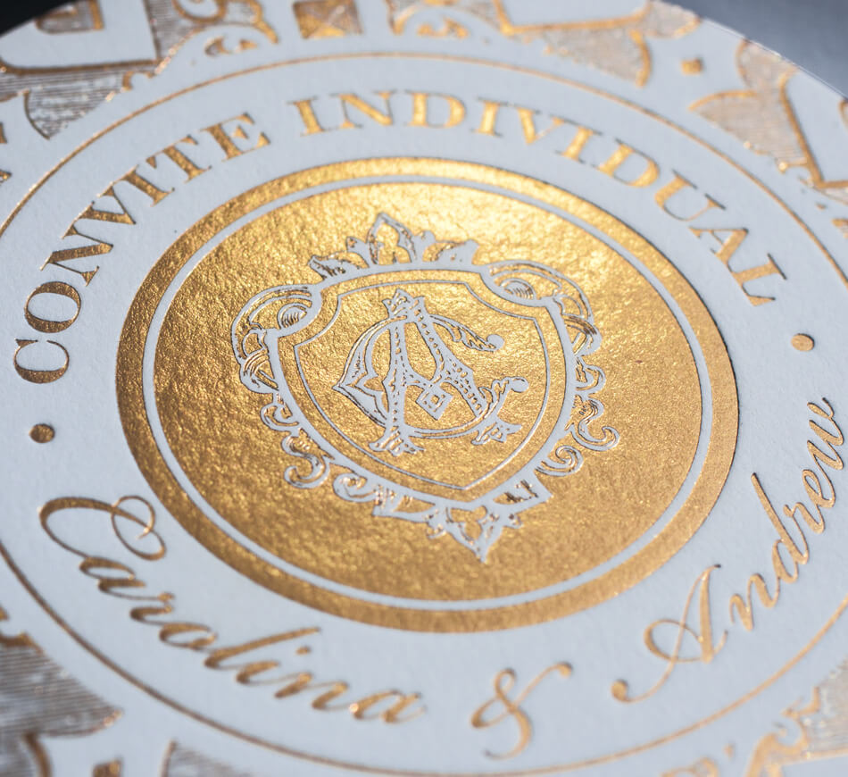 Gold foil crest on an entrance card