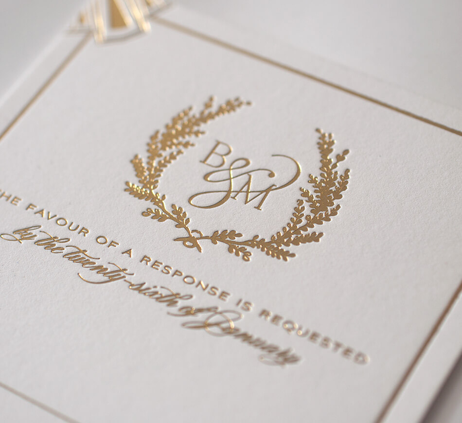 Gold foil monogram on ivory paper