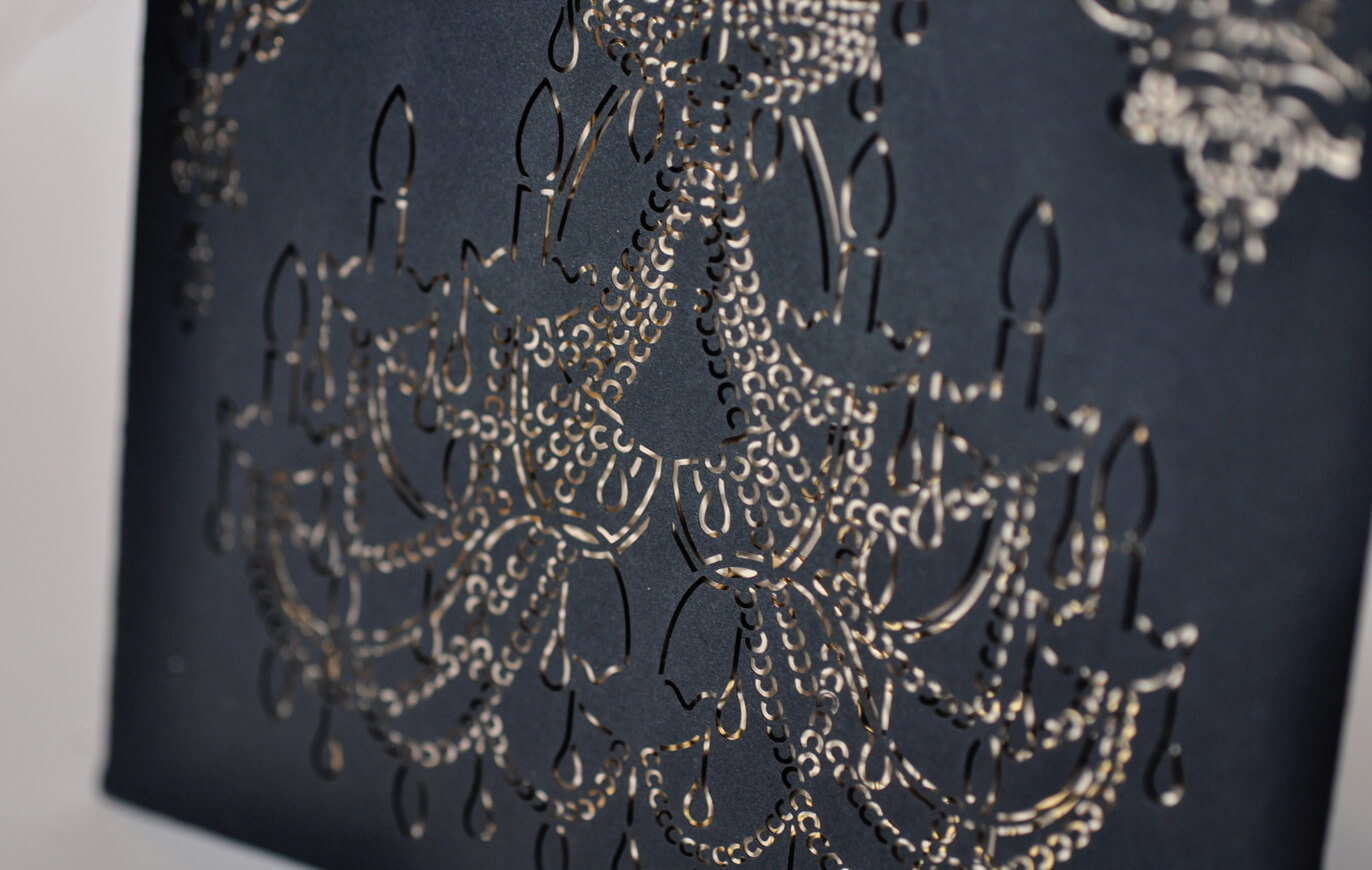 Laser cut chandelier detail on a black sleeve