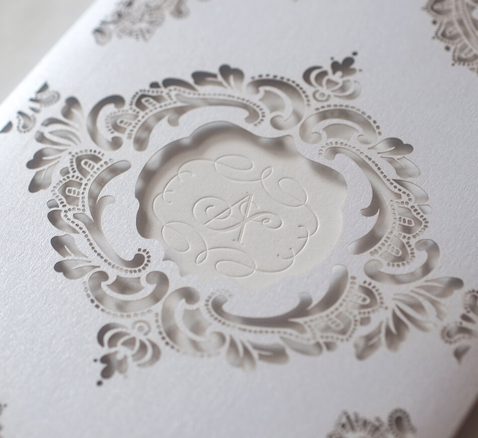 White shimmer laser cut sleeve revealing monogram