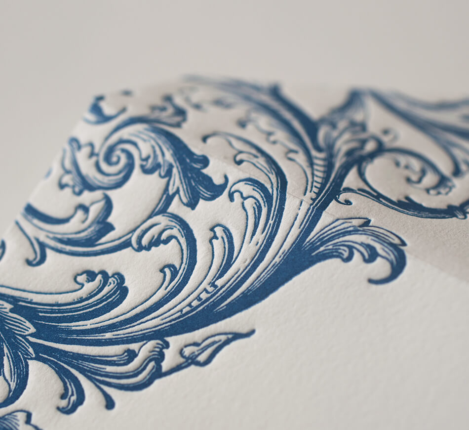Blue letterpress scroll on envelope